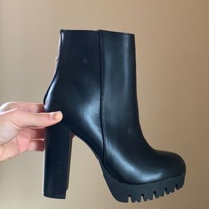 Black zip up booties with a large heel